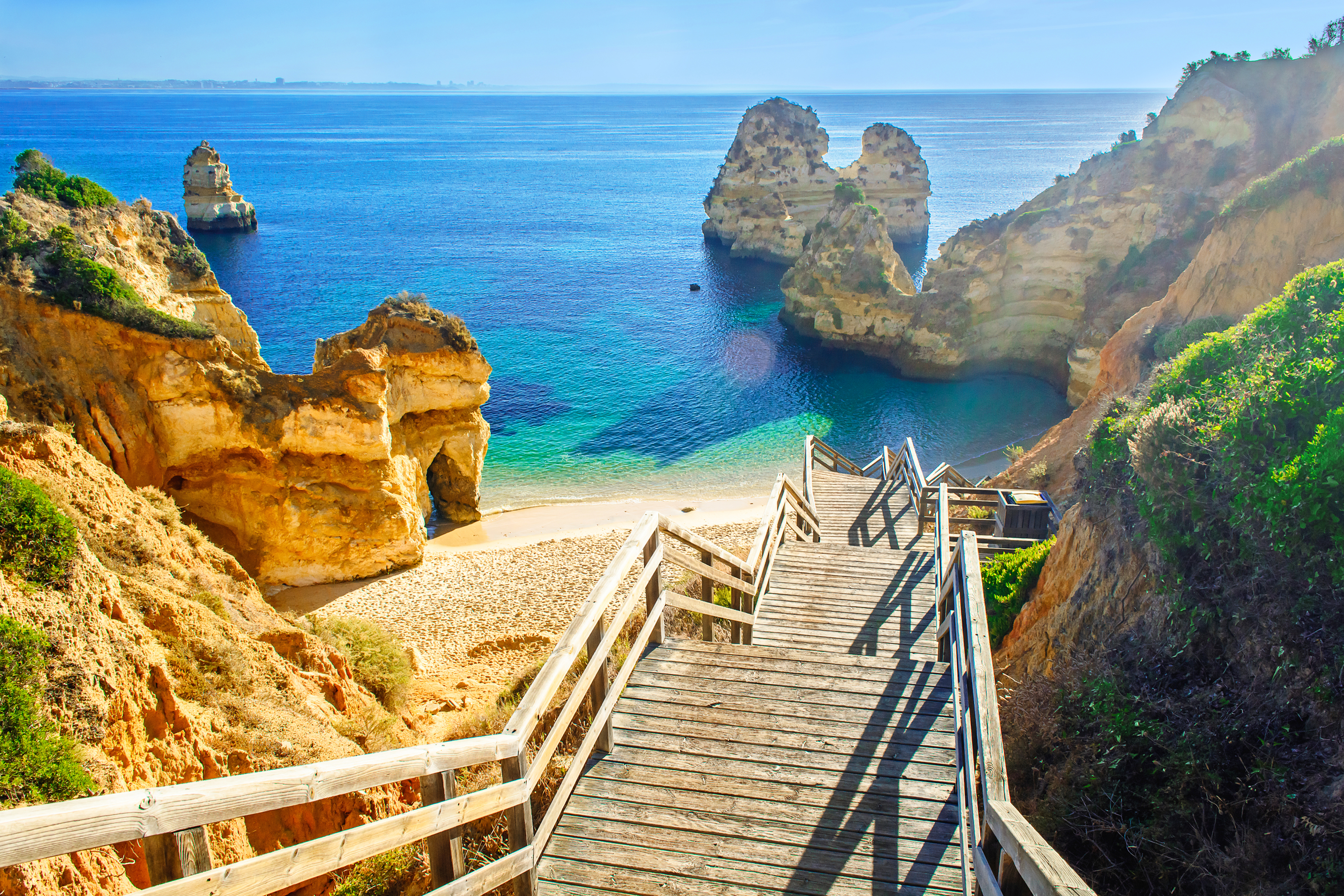 Praia do Camilo beach with turquoise waters at the end of the Fishermen's Trail hike in Algarve, Portugal.